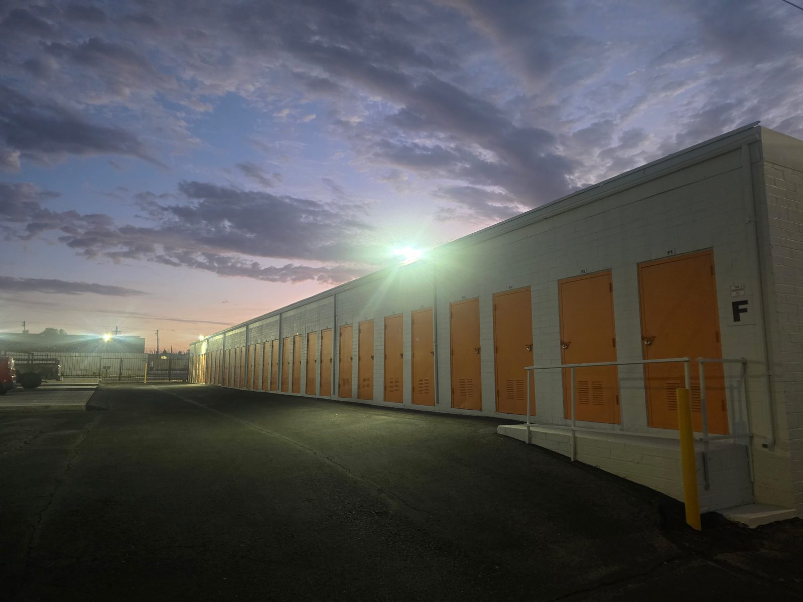 Freshly painted, floodlit row of drive-up units in building F at the Tucson facility